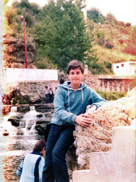 istock Teenage boy sitting outdoors and looking at the camera 1397067608