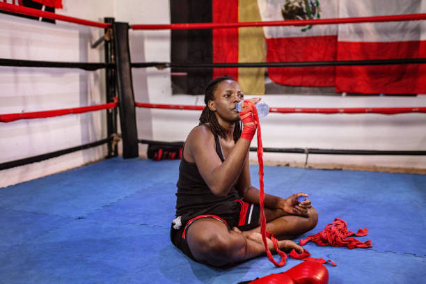 istock Black female boxer resting and refreshing herself in the ring 1397068356