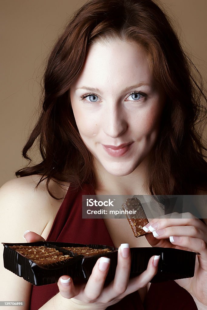 De cabelo vermelho mulher segurando uma caixa de chocolate. - Foto de stock de Adulto royalty-free