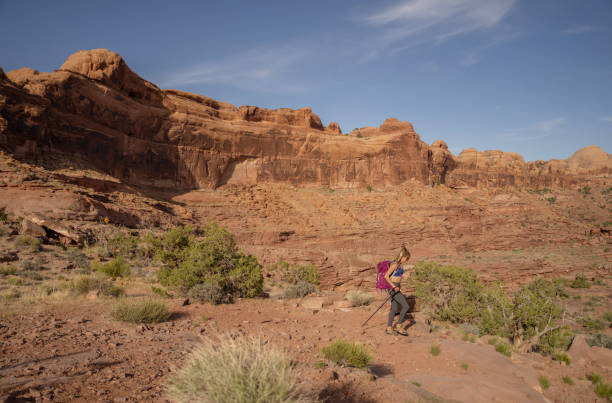 istock Female carrying backpack hiking in Moab park 1397069691