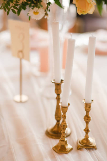 istock Table setting at the wedding reception. Floral compositions with beautiful flowers and greenery, candles, laying and plates on a decorated table. 1397071156