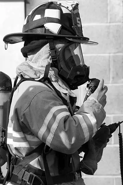 Profile of a (female) Firefighter all suited up and ready to go into the blaze!