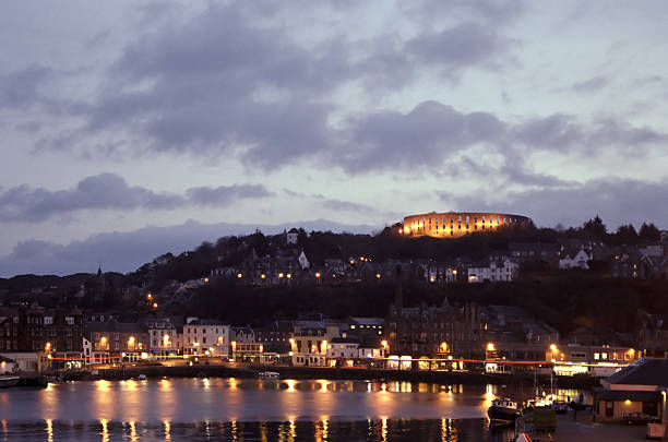 Oban Dawn A view of Oban, Scotland, from a ferry approaching the port at dawn on a winter morning. oban stock pictures, royalty-free photos & images