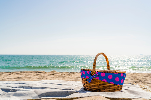 Picnic basket on sand by the beach. High resolution 42Mp outdoors digital capture taken with SONY A7rII and Zeiss Batis 40mm F2.0 CF lens