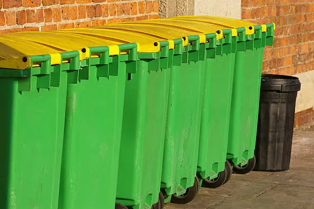 A series of green and yellow waste-bins down by the docks in Liverpool.