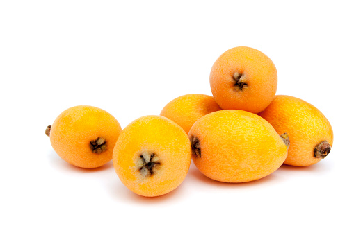 Loquats fruit isolated on white background. Group of Japanese orange fruit medlars, exotic, juicy sweet plums.