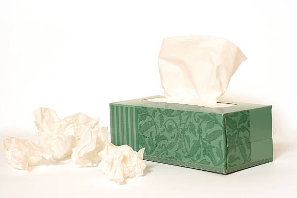 istock A box of tissues with used tissues next to it  139707765