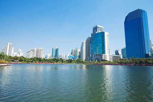 Lake of Benjakit Park and modern skyline of Bangkok