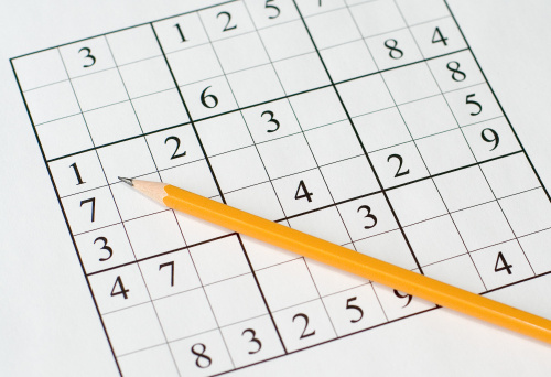 sudoku puzzle and yellow pencil