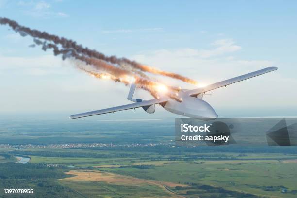 Blownup Strike Unmanned Military Drone Shot Down By An Enemy Missile In The Sky Over A Territory With Settlements Stock Photo - Download Image Now
