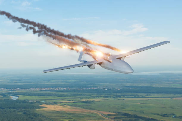 blown-up strike unmanned military drone shot down by an enemy missile in the sky over a territory with settlements. - exploding fire fighter plane war imagens e fotografias de stock