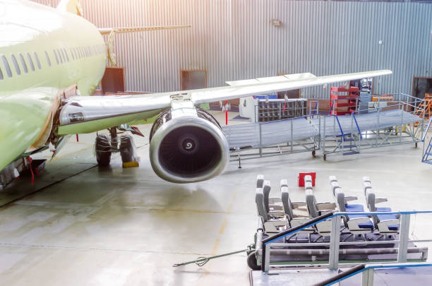 industrial theme, view in the hangar of the removed passenger seats on the trolley from the aircraft cabin, engine wing and fuselage. - fixed wing aircraft imagens e fotografias de stock