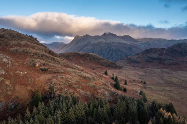 Beautiful aerial drone landscape image of sunrise from Blea Tarn in Lake District during stunning Autumn showing Epic aerial drone landscape image of sunrise from Blea Tarn in Lake District during stunning Autumn showing langdale pikes stock pictures, royalty-free photos & images