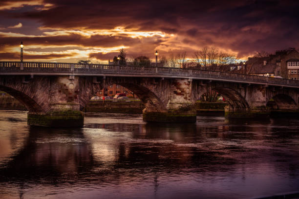 istock Historic composite Dumbarton sandstone arch bridge over river Leven with beautiful moody sunset sky. 1397080122