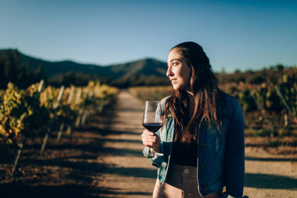 Young woman tasting red wine on vineyard Young woman tasting red wine on vineyard chilean ethnicity stock pictures, royalty-free photos & images