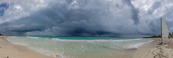 Panoramic image of an approaching thunderstorm off the gulf coast of mexico during the day