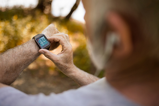 Senior Man using Smart Watch measuring heart rate