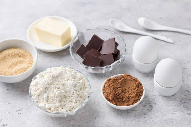istock Ingredients for making chocolate cake: flour, chocolate, cocoa, eggs, almonds, brown sugar, butter on gray textured background. Cooking delicious homemade food 1397085056