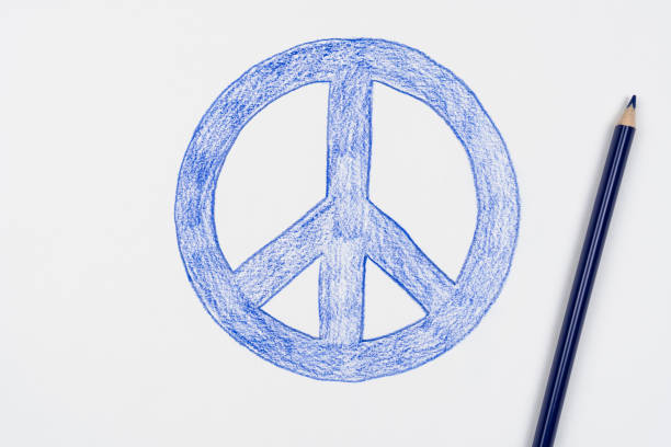 Peace symbol drawn with blue pensil on white paper.