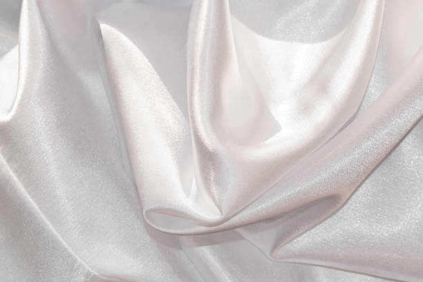 istock Close up of shiny white draped textile material. 1397088762