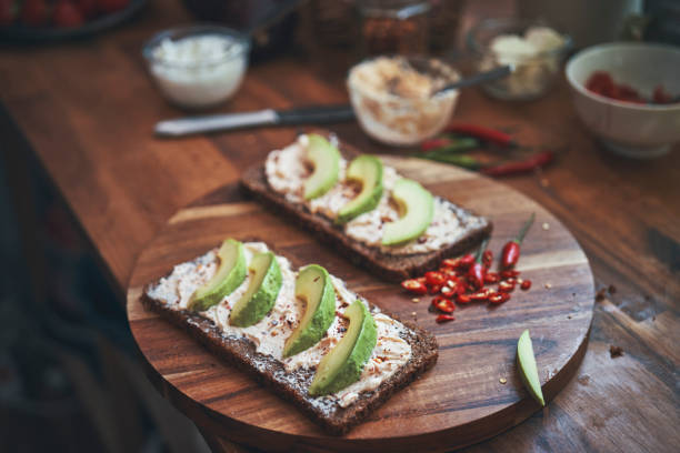 istock Preparing Avocado Sandwich with Brown Bread, Cottage Cheese and Chili 1397090065