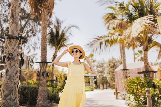 istock Woman walking on the beach looking at the sun 1397090272