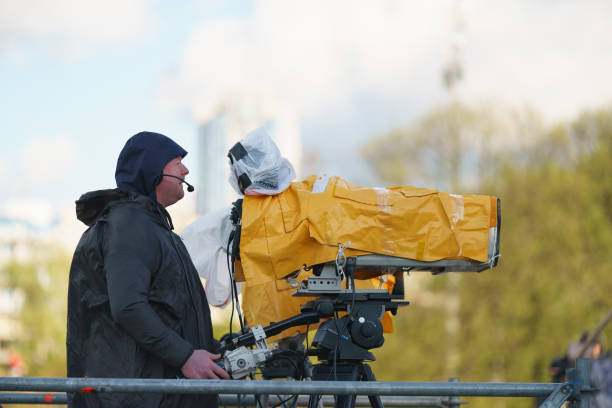 Female influencer talking to the camera with umbrella in street.