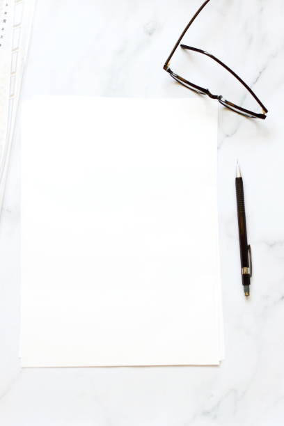 istock A4 format paper with glasses and pen on table 1397094179
