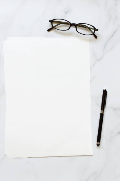istock A4 format paper with glasses and pen on table 1397094181