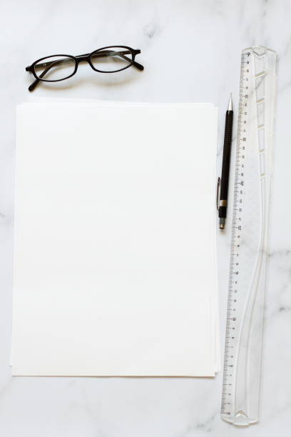 istock A4 format paper with glasses and pen on table 1397094182