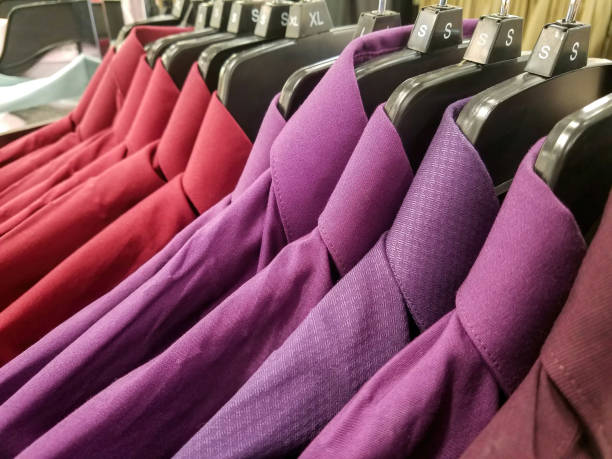 istock Red and Purple Shirts on a Coat Rack Close-up 1397094388