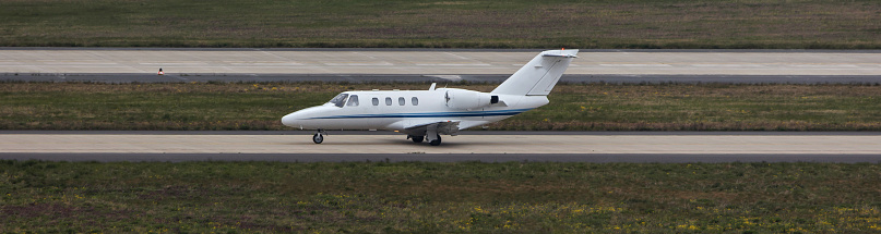 a modern private jet on an airport runway