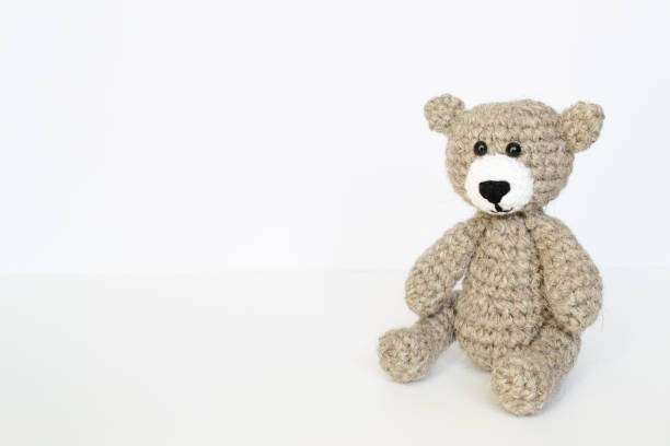istock Crochet gray bear on white background. Crocheted bear 1397098789
