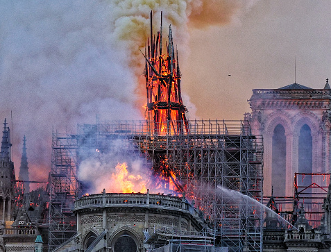 Paris, France - April the 15th 2019. Notre Dame devastated by fire with a fireman fighting against the blazes.