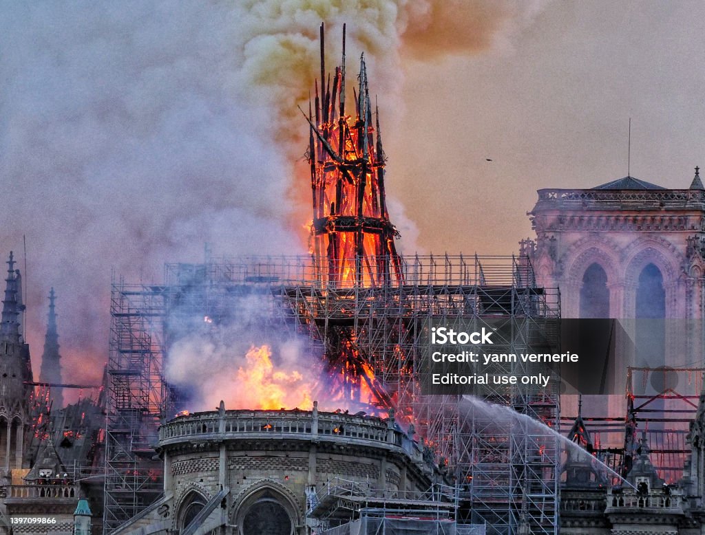 A fireman alone against a huge fire. Paris, France - April the 15th 2019. Notre Dame devastated by fire with a fireman fighting against the blazes. Notre Dame de Paris Stock Photo
