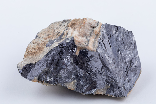 Galena rock specimen. The raw mineral lead sulphide with a distinct weight and shiny metalic colour in a white matrix of fluorite. The most important ore of lead and a source of silver.