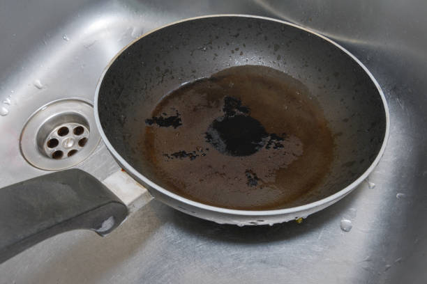 istock Burned frying pan in the kitchen sink. A close-up view. 1397101133