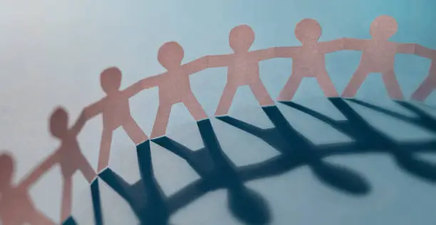 Photo of Paper human chain as a symbol of cohesion