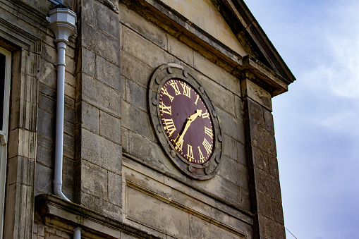 St. Andrews, Scotland, United Kingdom - April 28, 2022: View of the wall clock on the Royal and Ancient Gold Club of St Andrews clubhouse, near the first tee at the Old Course. St Andrews is the oldest golf course in existence.