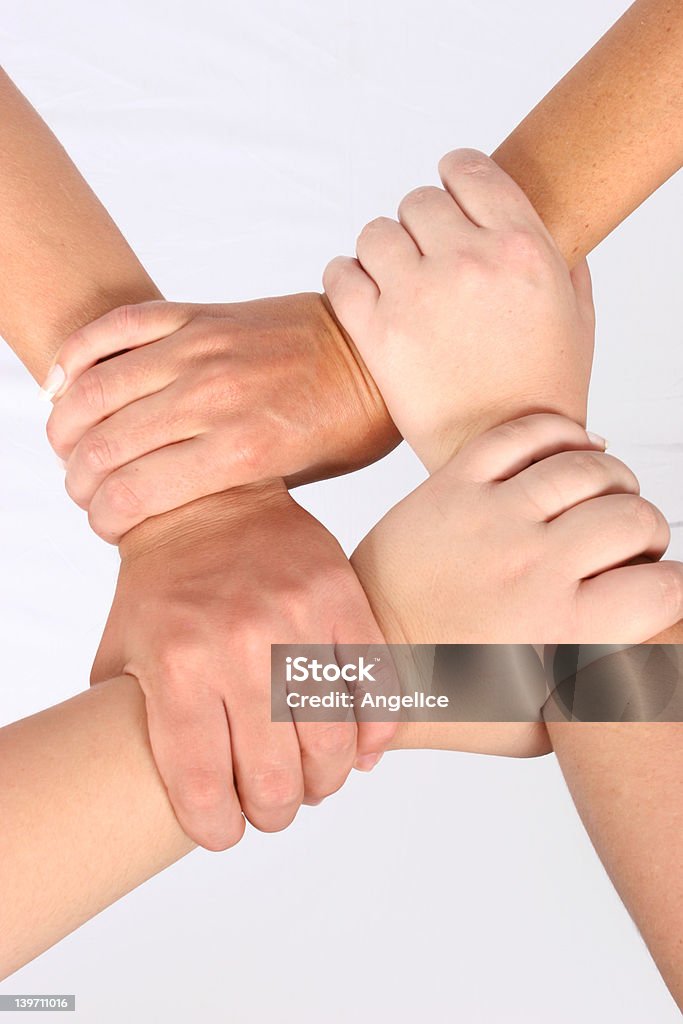 Interlocked hands Interlocked hands of four people Circle Stock Photo