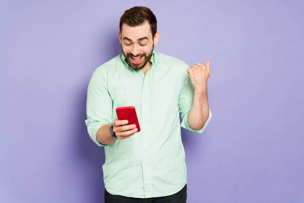 istock Excited man texting on his new phone 1397113402