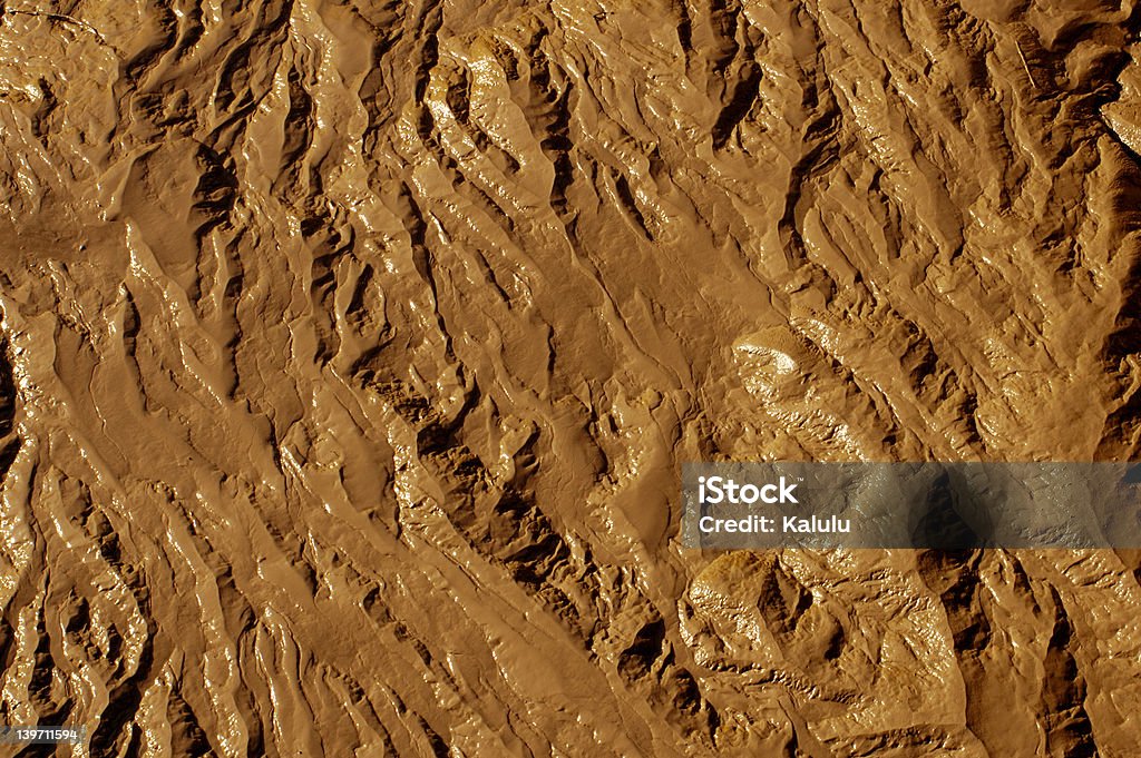 Terrain texture background Wet mud exposed at low tide on the River Avon at Bristol, UK. Shows a terrain-like texture. Could be a desert from the air, the moon, a martian landscape ... anywhere. Abstract Stock Photo