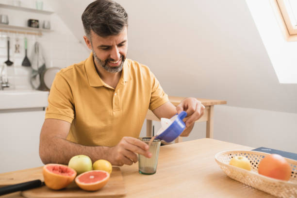 istock Man pouring citrus juice 1397116026