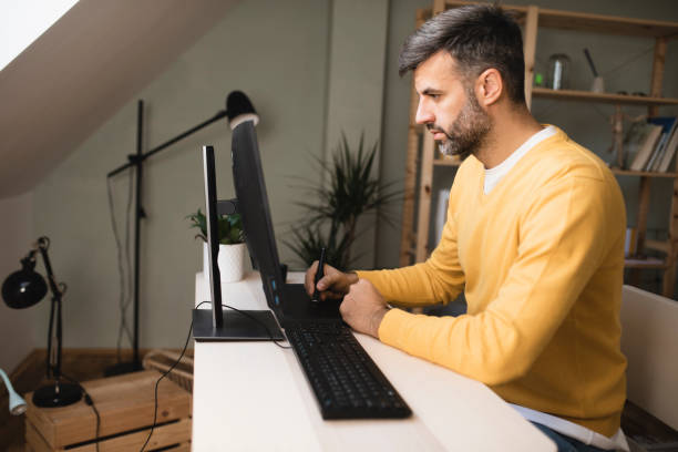 istock Graphic designer freelancing from his home office 1397116050