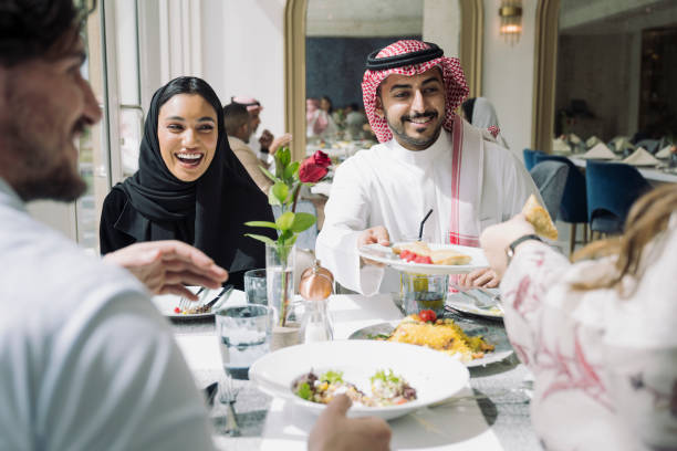 istock Cheerful Middle Eastern friends sharing food at lunch 1397116174