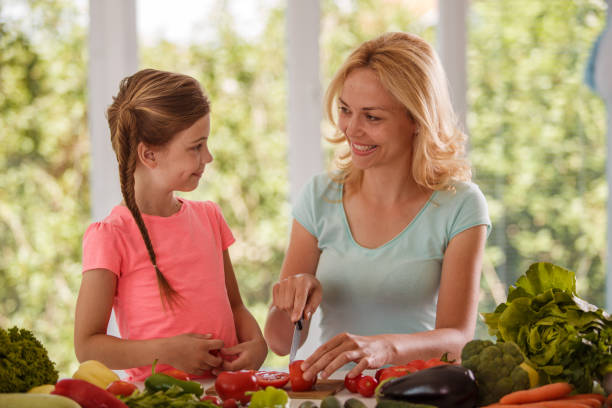 istock Mother and daughter bonding while preparing healthy food 1397116408