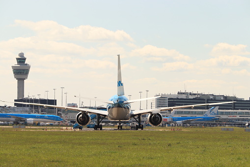 Amsterdam Airport Schiphol, The Netherlands -  May 5th 2020: Airport in Corona lockdown. Limited air traffic keeps planes grounded. KLM Boeing