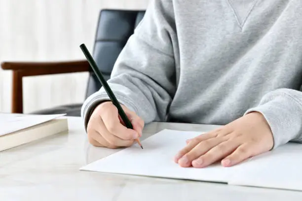 Photo of Child doing homework in living room