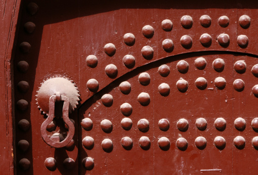 An old knocker on a door of a traditional Moroccan house in Marrakech, Morocco.