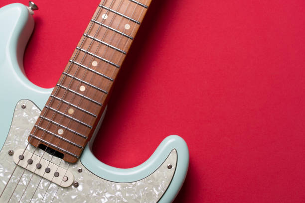 istock Electric guitar on red table background, close up music concept 1397120558